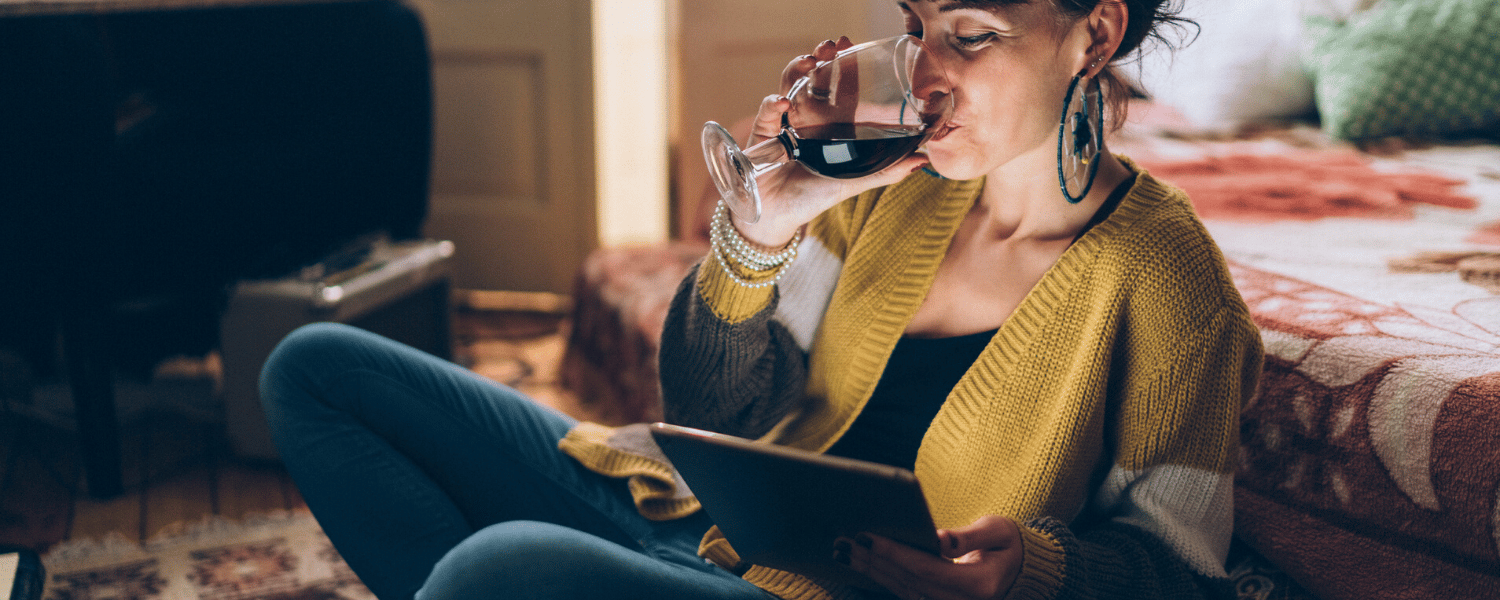 Social Hour Blog | Social Media Advertising Service | Woman Sips Wine While Looking at Tablet