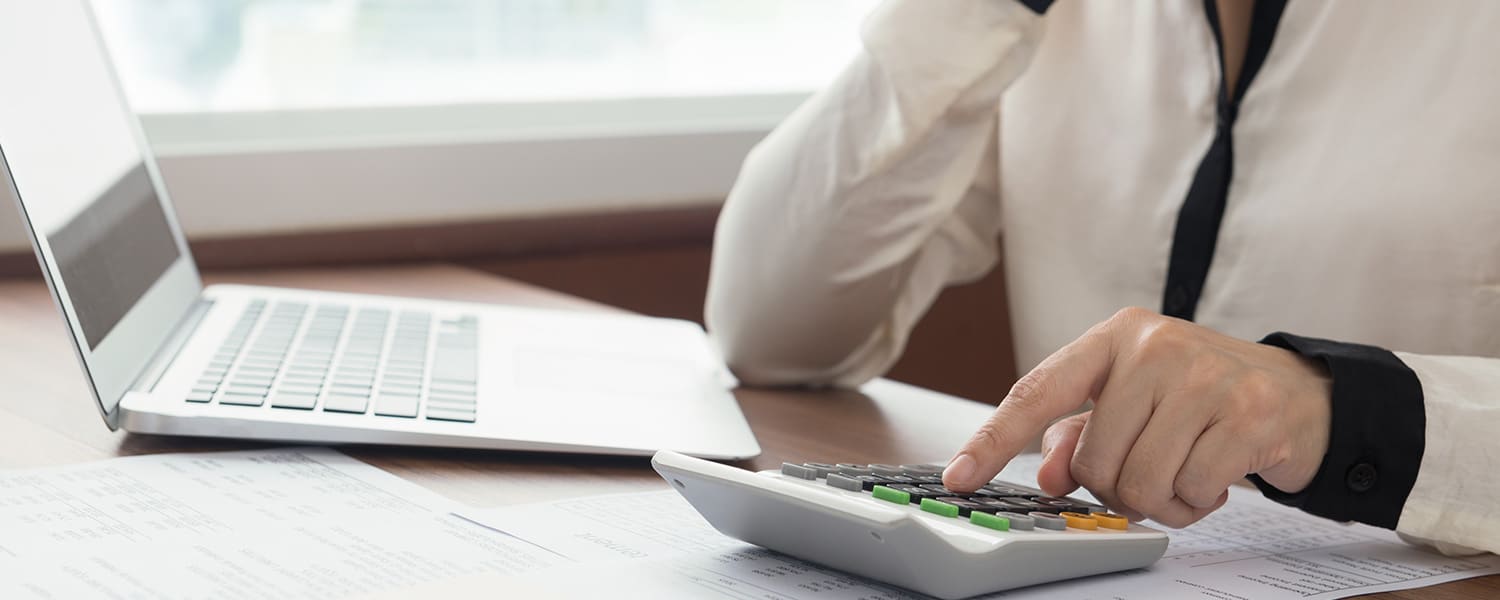 Calculating ROI on Advertising | How to Calculate ROI | Employee Doing Calculations at Desk
