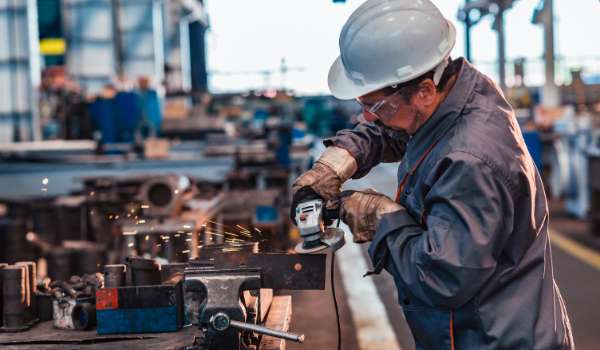Manufacturing professional working with machinery in warehouse